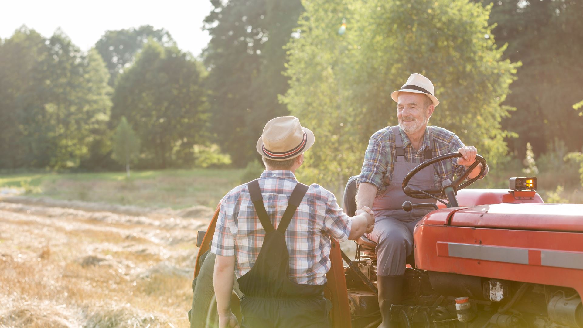 Two farmers talking and shaking hands